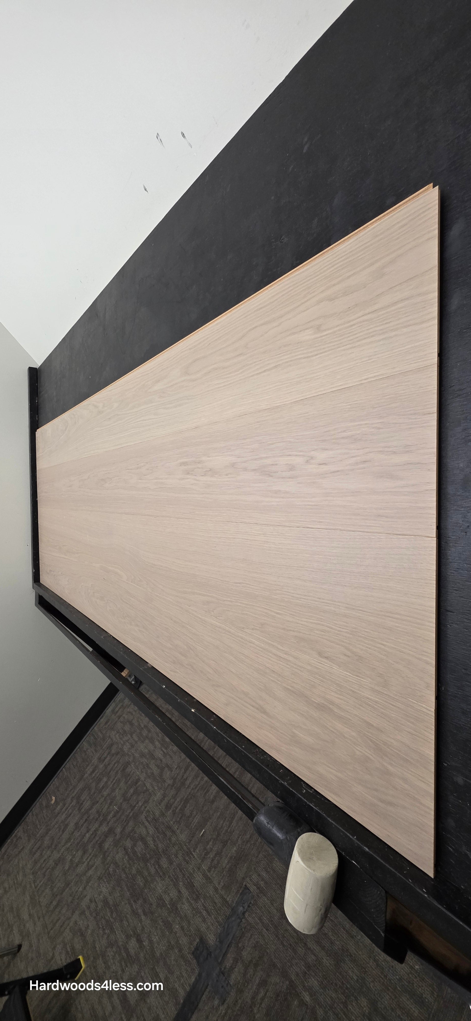 8.11" x 7/16" Modernized Engineered European Oak Foster Hardened Hardwood Flooring. Shown on a black shooting table. Shot from steep right.