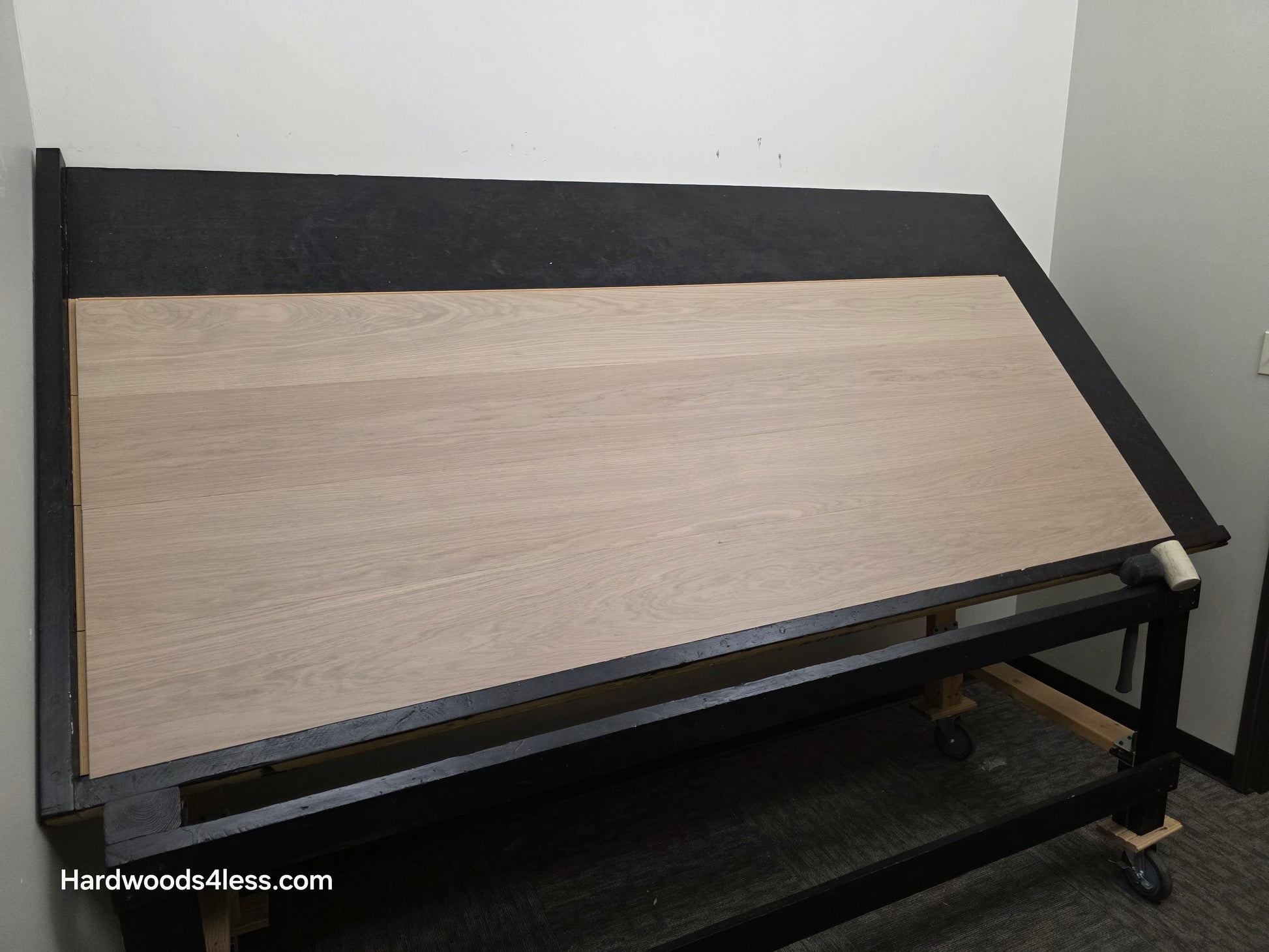 8.11" x 7/16" Modernized Engineered European Oak Foster Hardened Hardwood Flooring. Shown on a black shooting table. Shot from wide left.