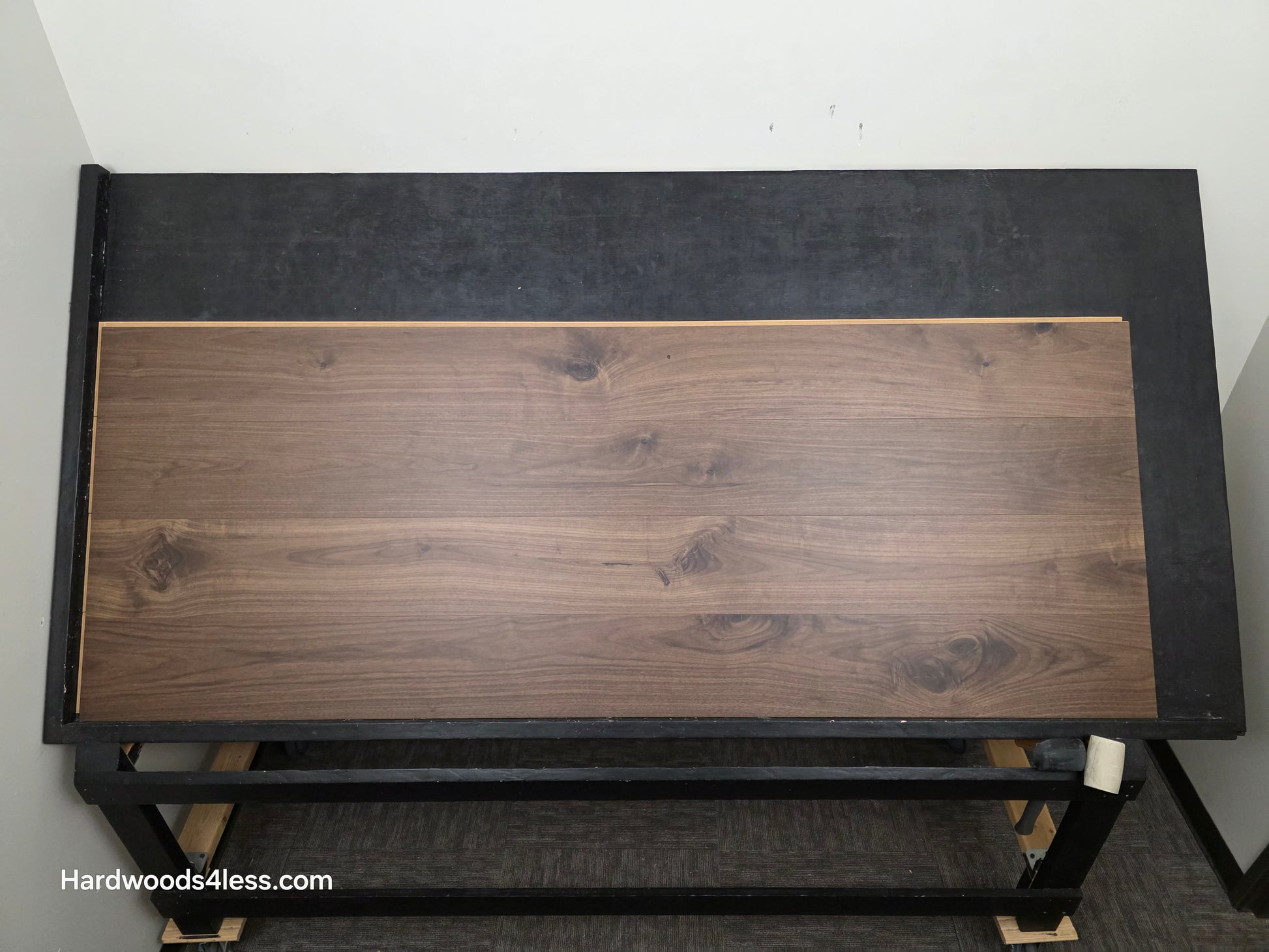 8.11" x 7/16" Modernized Engineered Walnut Calatrava Hardened Hardwood Flooring. Shown on a black shooting table. Shot from center.