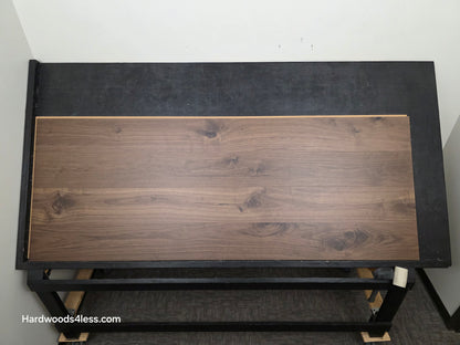 8.11" x 7/16" Modernized Engineered Walnut Calatrava Hardened Hardwood Flooring. Shown on a black shooting table. Shot from center.