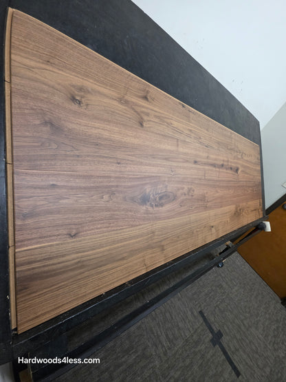 8.11" x 7/16" Modernized Engineered Walnut Wright Hardened Hardwood Flooring. Shown on a black shooting table. Shot from steep left.