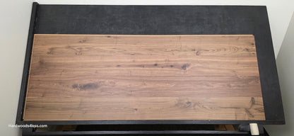 8.11" x 7/16" Modernized Engineered Walnut Wright Hardened Hardwood Flooring. Shown on a black shooting table. Shot from center.
