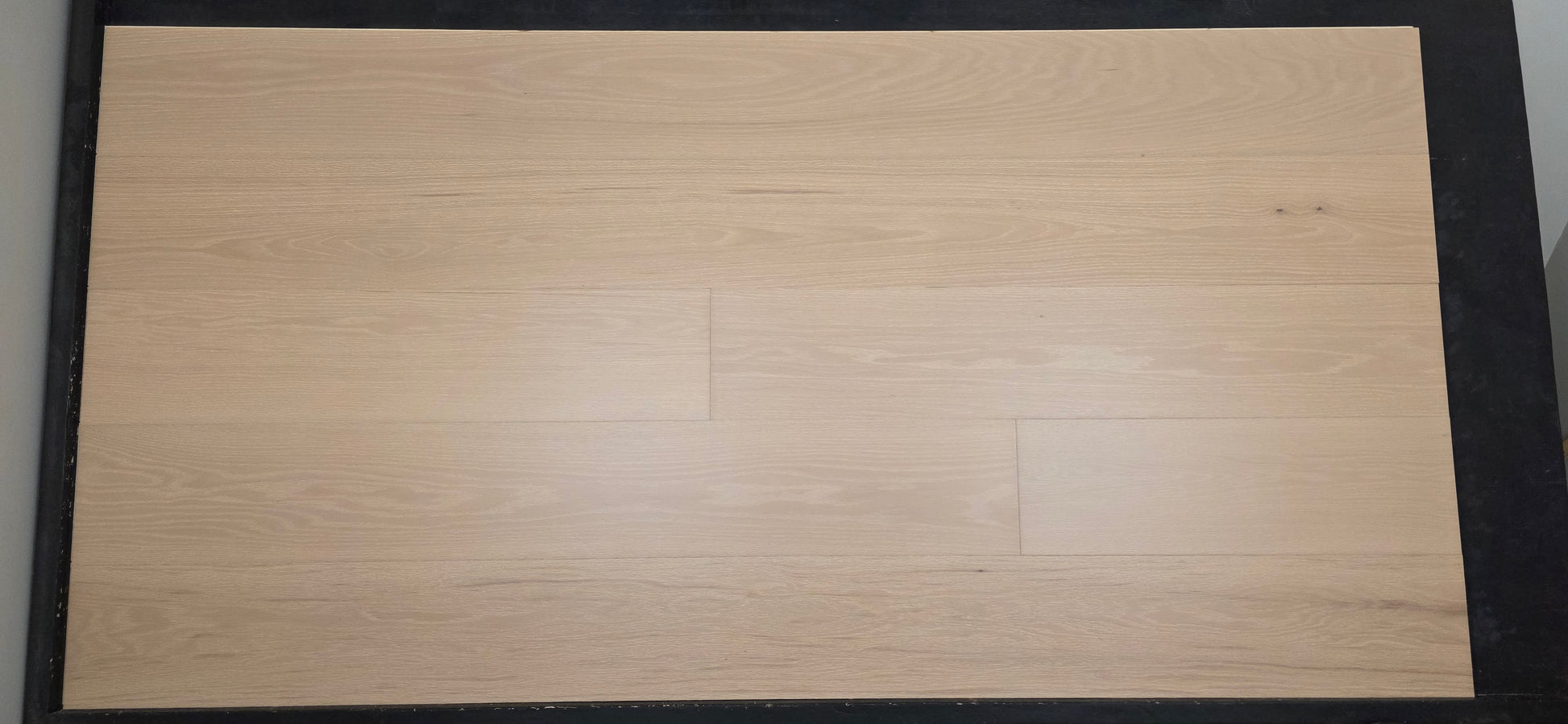 Engineered European Oak Loire Hardwood Flooring mid range shot tan wood black rack 