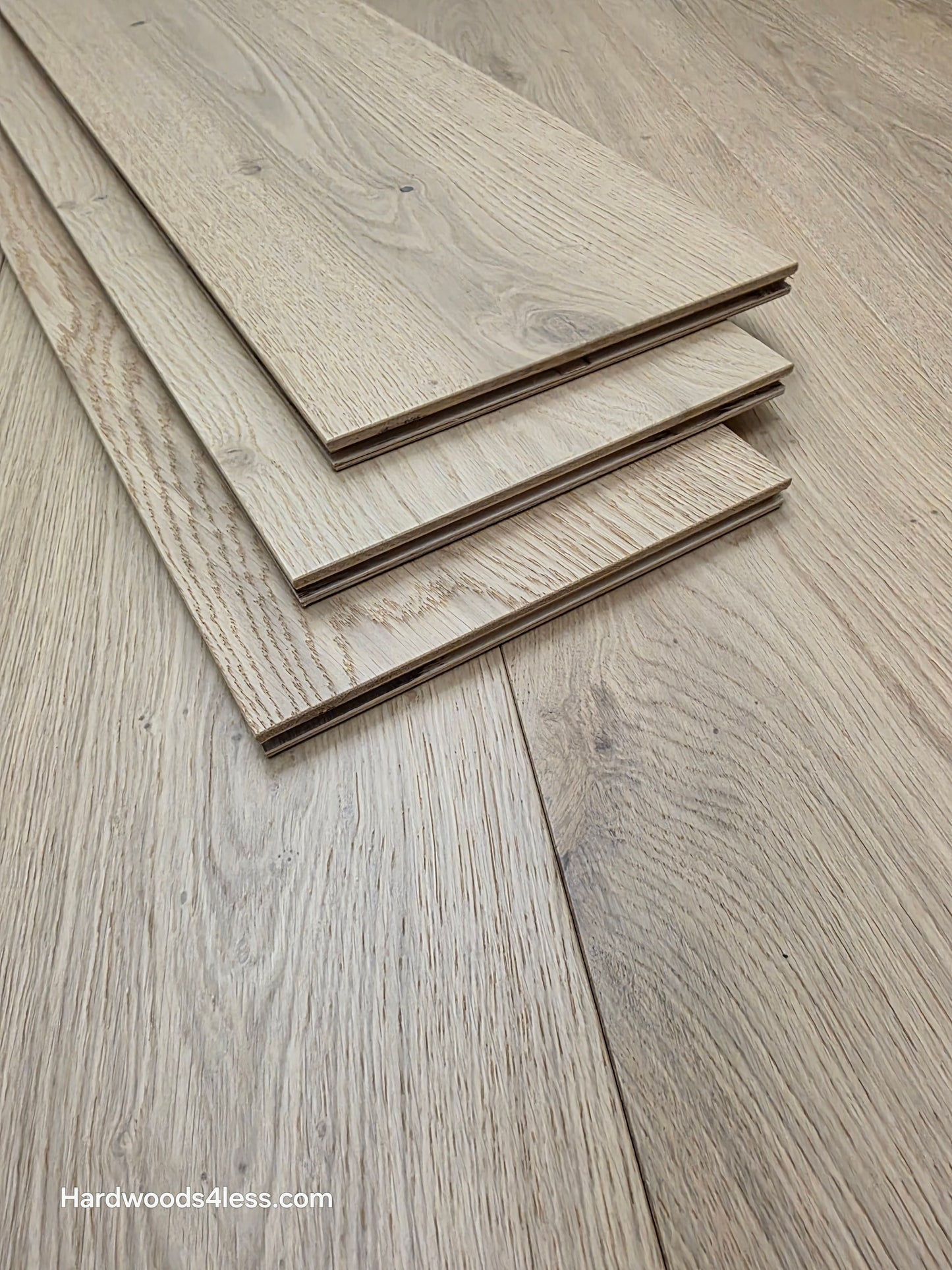 8.66" x 5/8" Engineered European Oak Pismo Stain Hardwood Flooring. Shown as 3 tiles stacked on the floor. Shot very close up. 