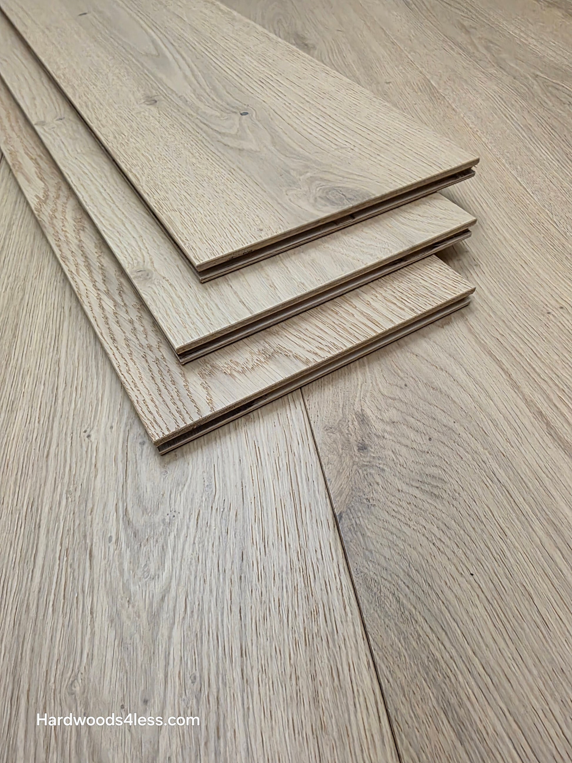 8.66" x 5/8" Engineered European Oak Pismo Stain Hardwood Flooring. Shown as 3 tiles stacked on the floor. Shot very close up. 