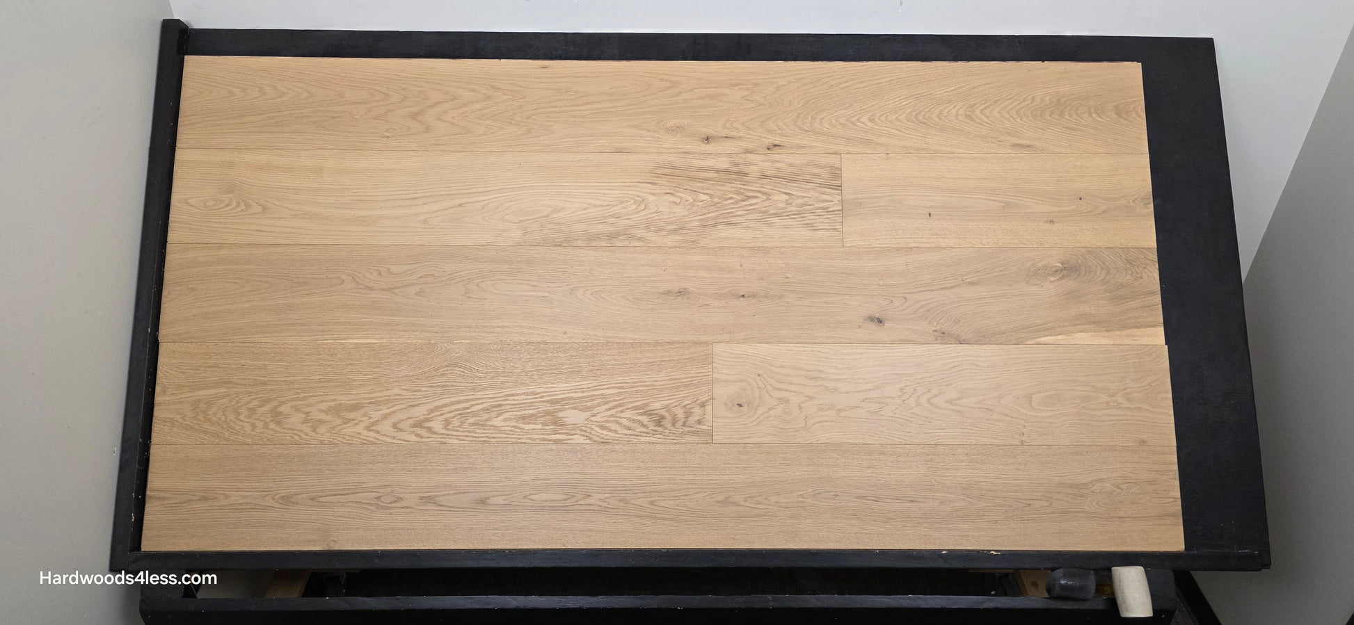 8.66" x 5/8" Engineered European Oak Pismo Stain Hardwood Flooring. Shown on a black shooting table. Shot from center.
