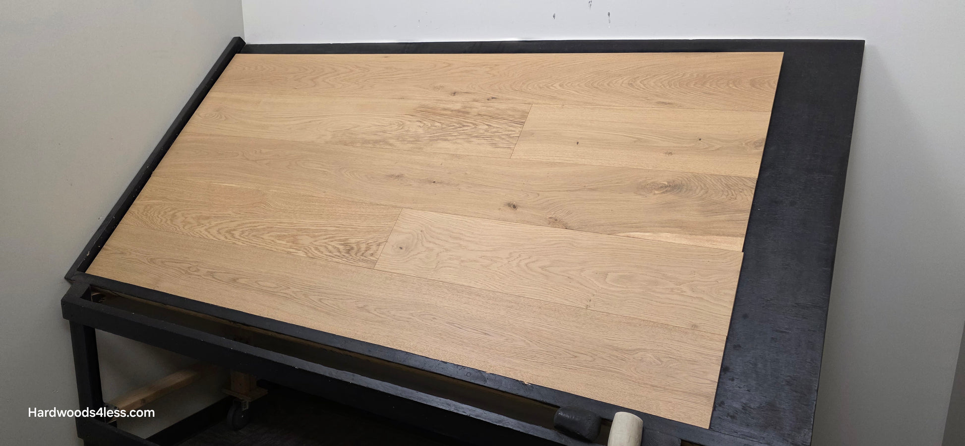 8.66" x 5/8" Engineered European Oak Pismo Stain Hardwood Flooring. Shown on a black shooting table. Shot from wide right.