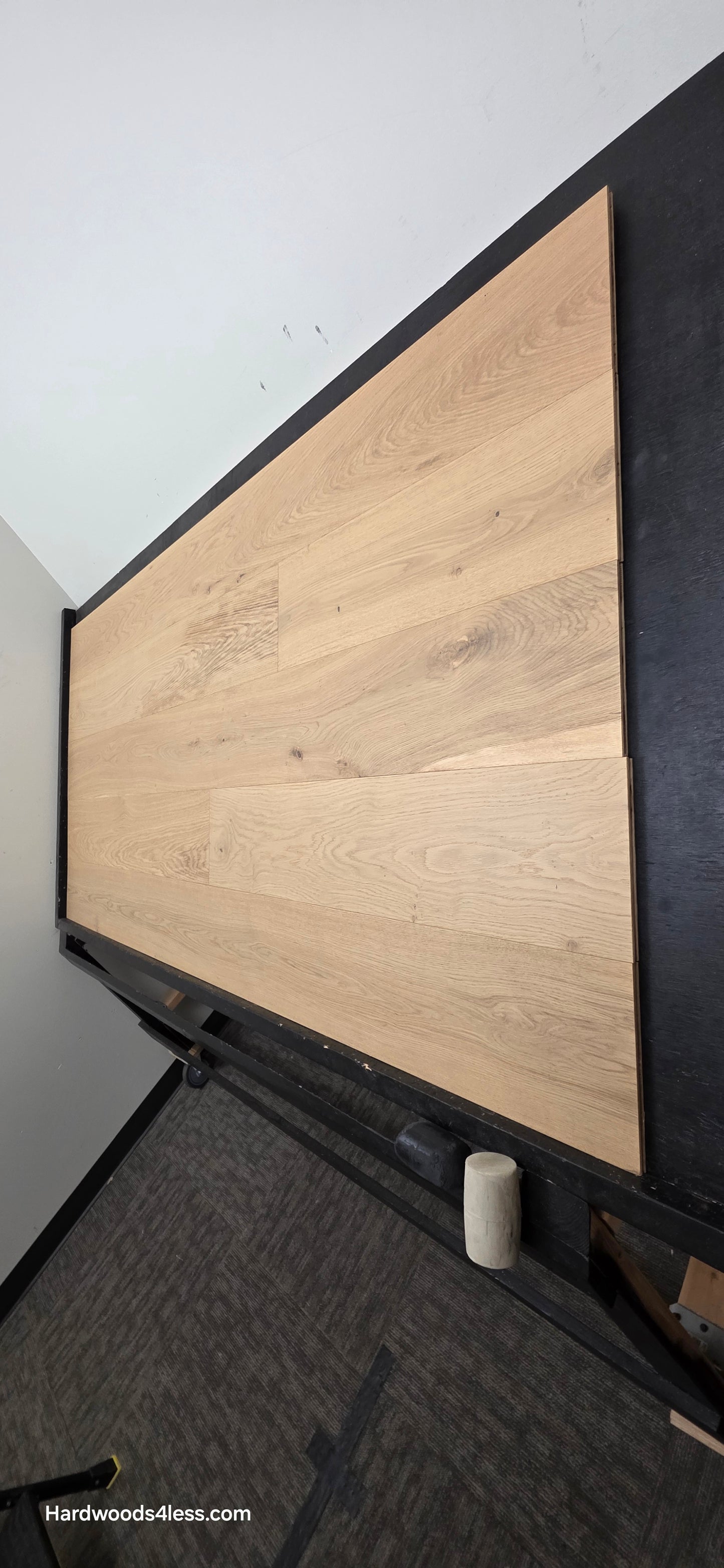 8.66" x 5/8" Engineered European Oak Pismo Stain Hardwood Flooring. Shown on a black shooting table. Shot from steep left. 