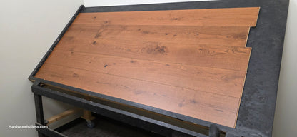 8 1/4" x 9/16" Engineered European Oak Corinth Hardwood Flooring. Shown on a black shooting rack. shot low right.