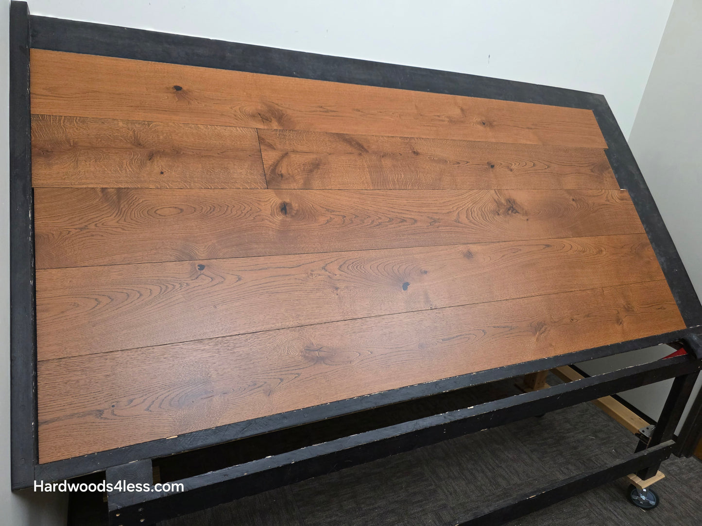 8 1/4" x 9/16" Engineered European Oak Corinth Hardwood Flooring. Shown on a black shooting rack. shot low left.