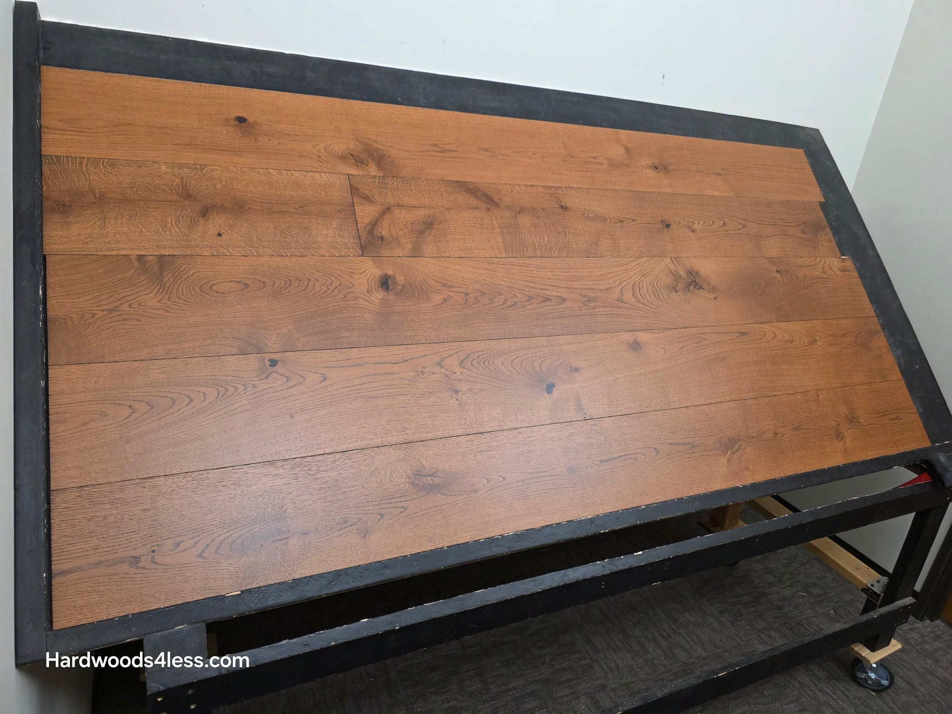 8 1/4" x 9/16" Engineered European Oak Corinth Hardwood Flooring. Shown on a black shooting rack. shot low left.