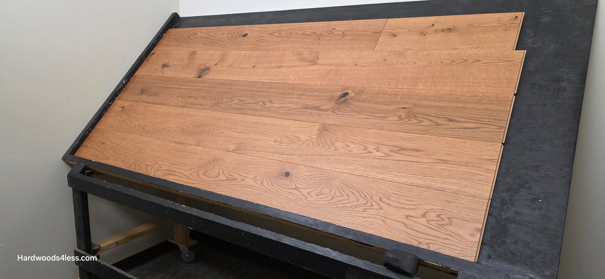 8 1/4" x 9/16" Engineered European Oak Helios Hardwood Flooring. Shown on a black shooting table. Shot from the right side.