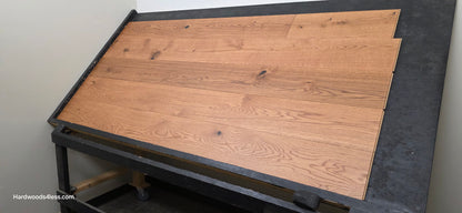8 1/4" x 9/16" Engineered European Oak Helios Hardwood Flooring. Shown on a black shooting table. Shot from the right side.