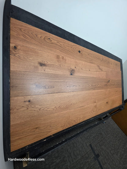 8 1/4" x 9/16" Engineered European Oak Helios Hardwood Flooring. Shown on a black shooting table. Steep left angle shot. 