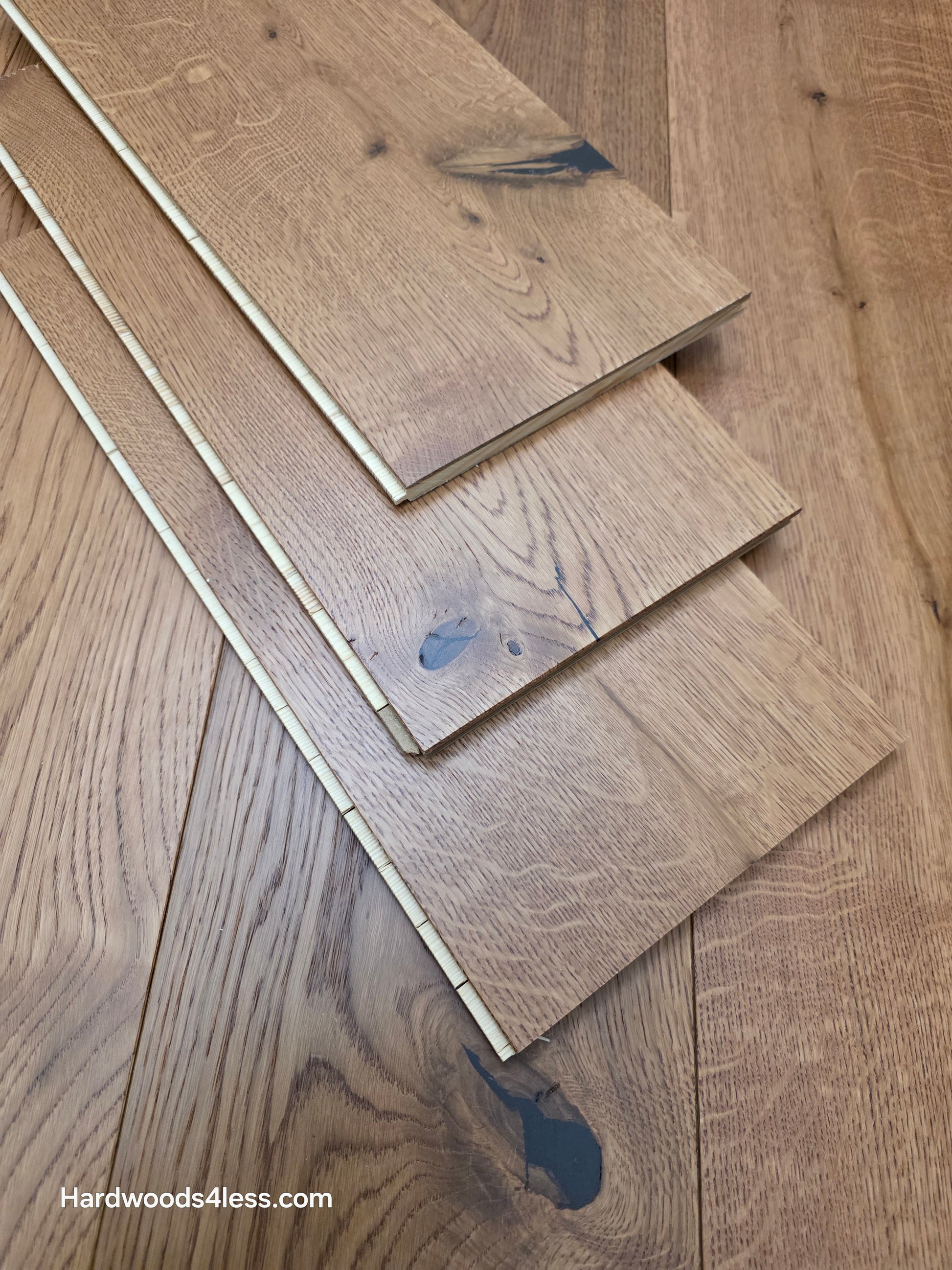 8 1/4" x 9/16" Engineered European Oak Helios Hardwood Flooring. Shown as 3 tiles stacked on top of the flooring. 