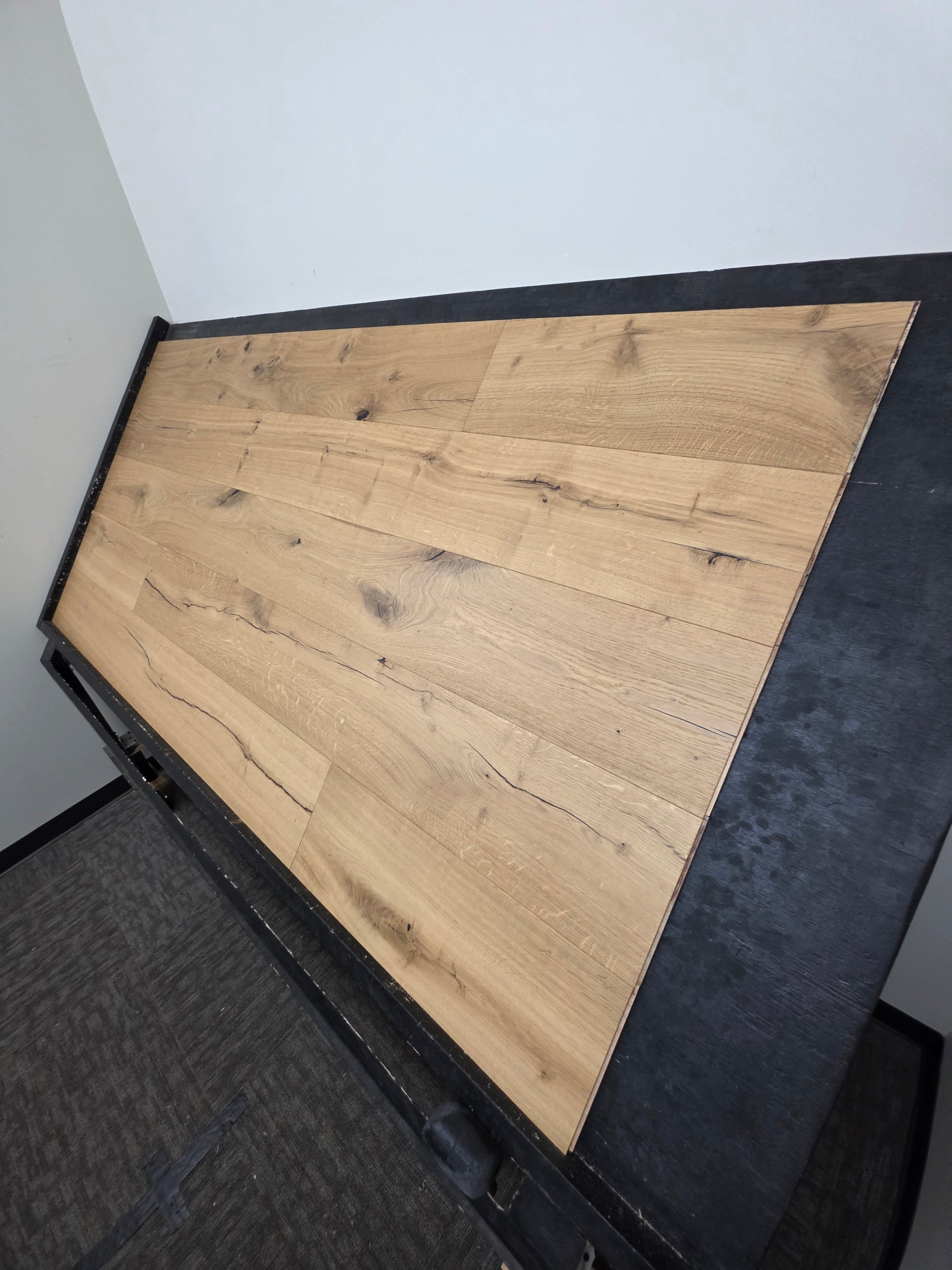 European White Oak hardwood flooring on a black racking table. Long wide shot right side