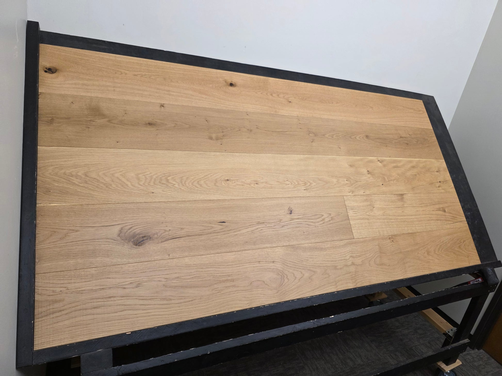 8 5/8" x 5/8" Engineered European Oak Buckwheat Hardwood Flooring shown on a black shooting table. Left side wide shot