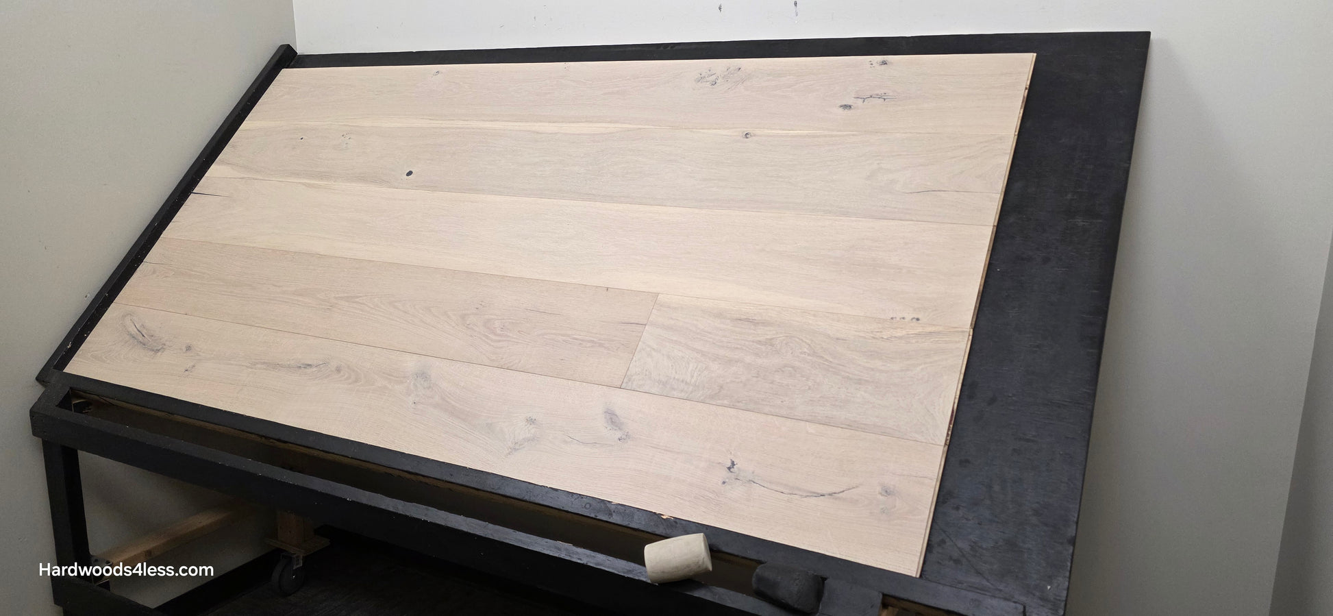 8 5/8" x 5/8" Engineered European Oak Granacci Hardwood Flooring. Shown on a black shooting table. Shot from wide right.