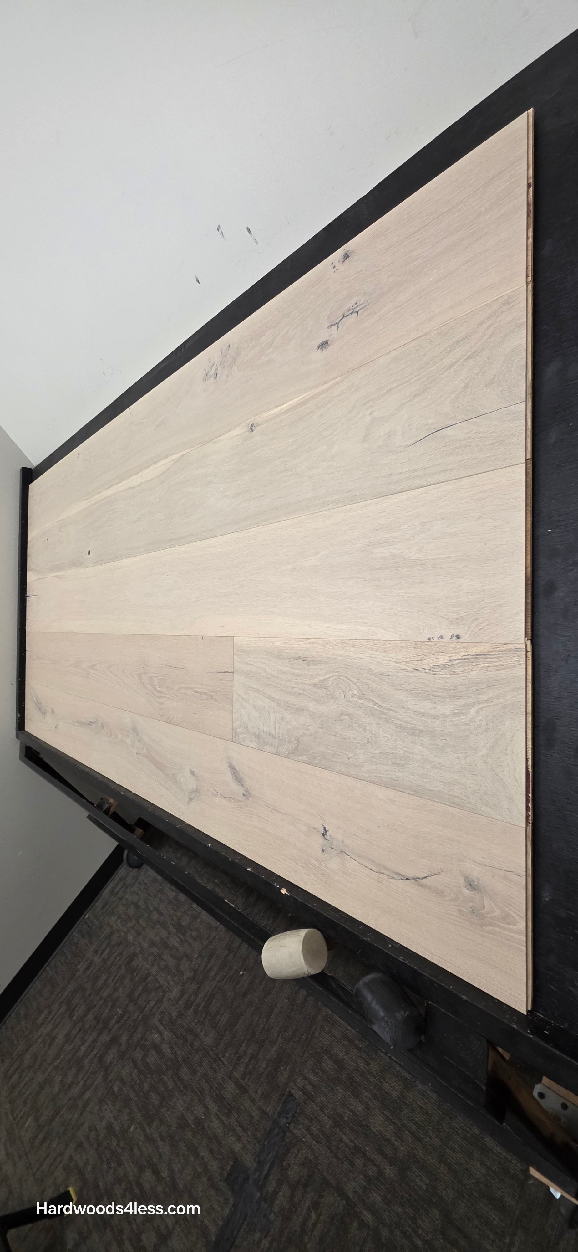 8 5/8" x 5/8" Engineered European Oak Granacci Hardwood Flooring. Shown on a black shooting table. Shot from steep right.
