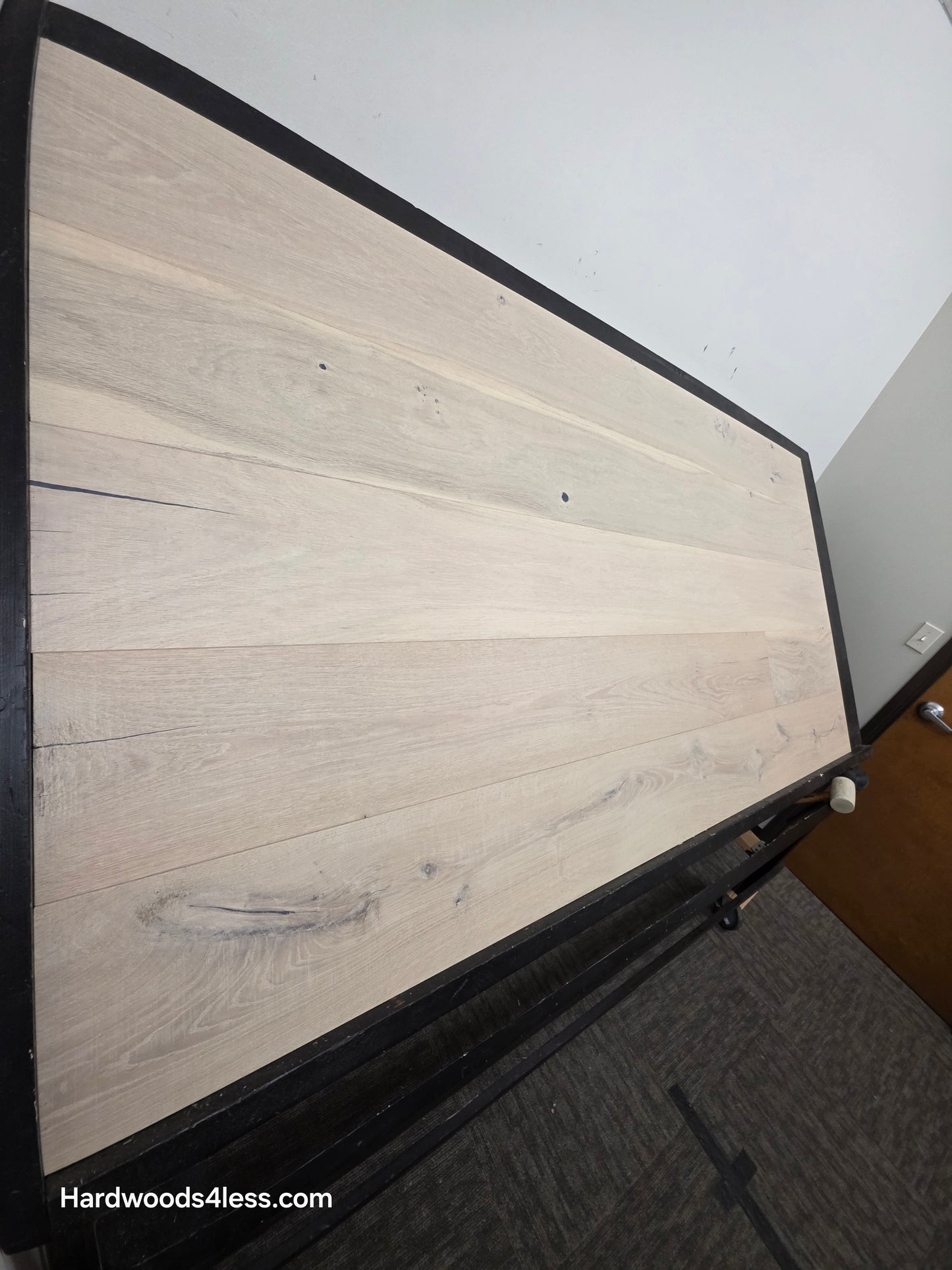 8 5/8" x 5/8" Engineered European Oak Granacci Hardwood Flooring. Shown on a black shooting table. Shot from steep left. 