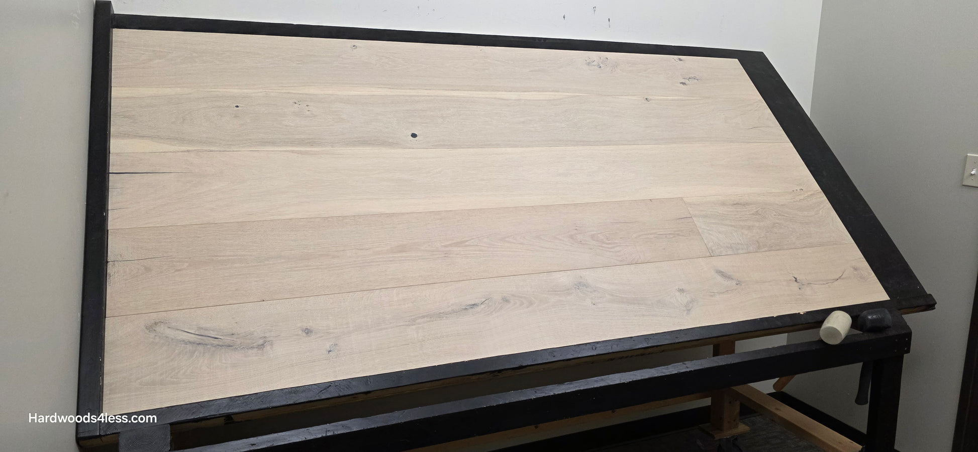 8 5/8" x 5/8" Engineered European Oak Granacci Hardwood Flooring. Shown on a black shooting table. Shot from wide left. 