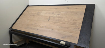 8 5/8" x 5/8" Engineered European Oak Highball Hardwood Flooring. Shown on a black shooting table. Shot from wide right.