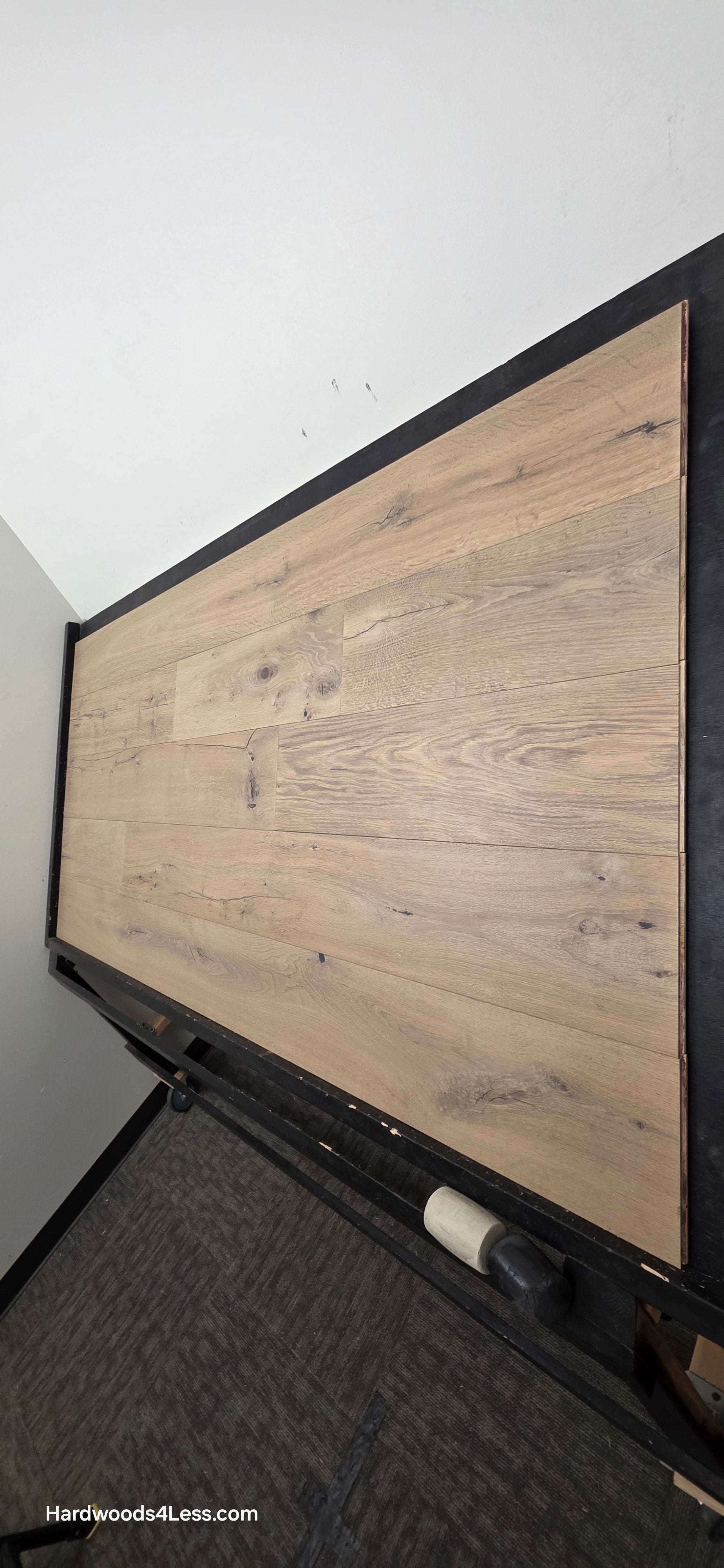 8 5/8" x 5/8" Engineered European Oak Highball Hardwood Flooring. Shown on a black shooting table. Shot from steep right.