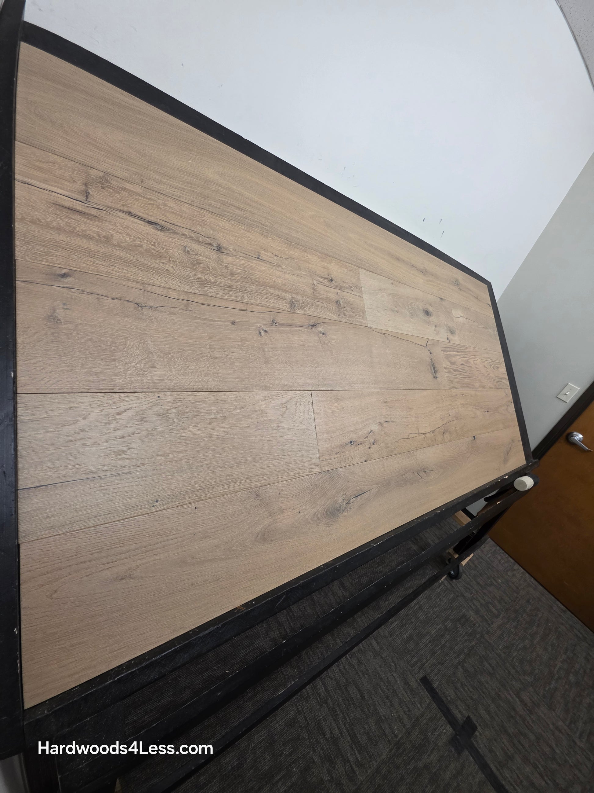 8 5/8" x 5/8" Engineered European Oak Highball Hardwood Flooring. Shown on a black shooting table. Shot from steep left. 
