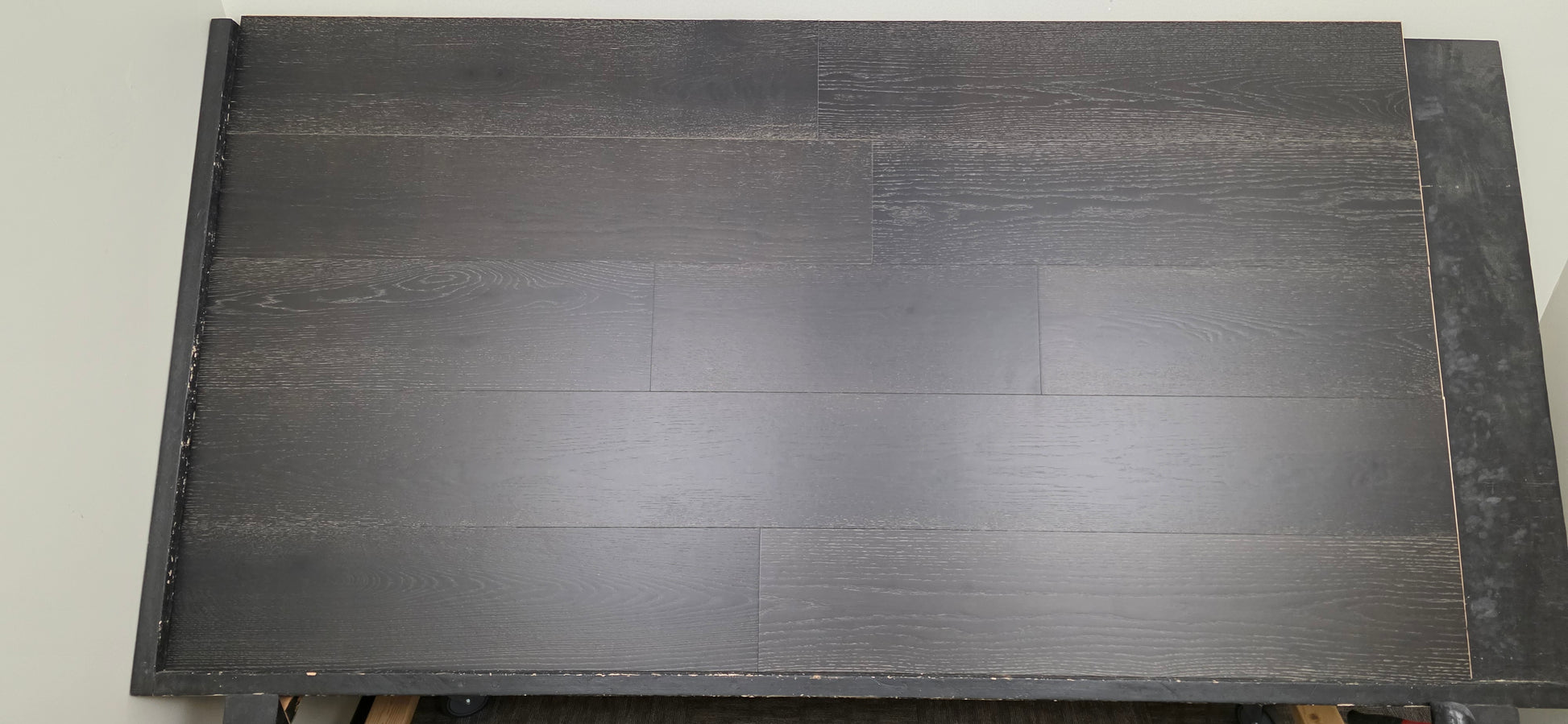 9 1/2" x 5/8" Engineered Red Oak Uriel Hardwood Flooring wide angle front shot on a black shooting rack.