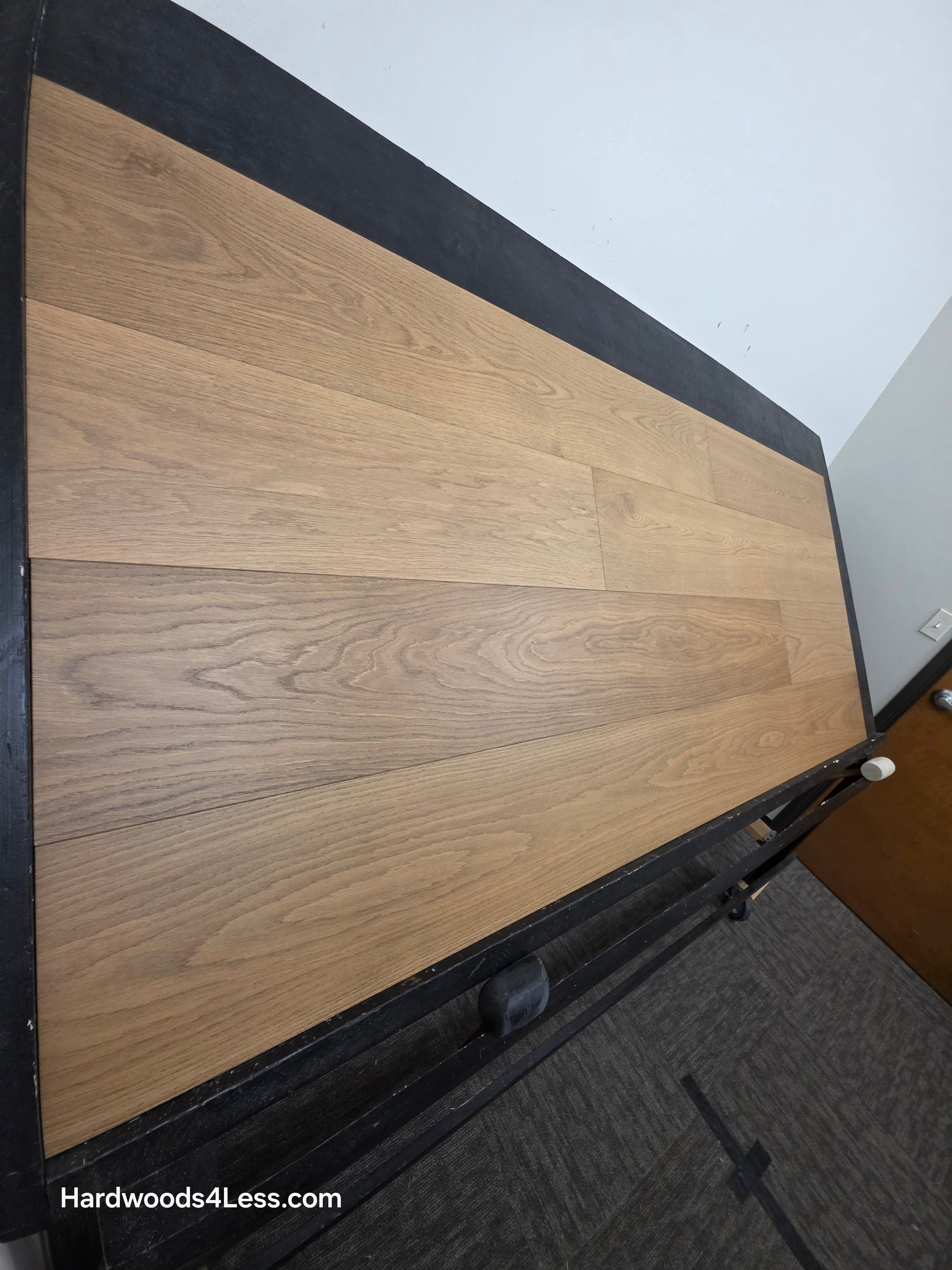 9 1/2" x 3/4" Engineered European Oak Albion Hardwood Flooring. Show on a black shooting table. Shot from steep left. 