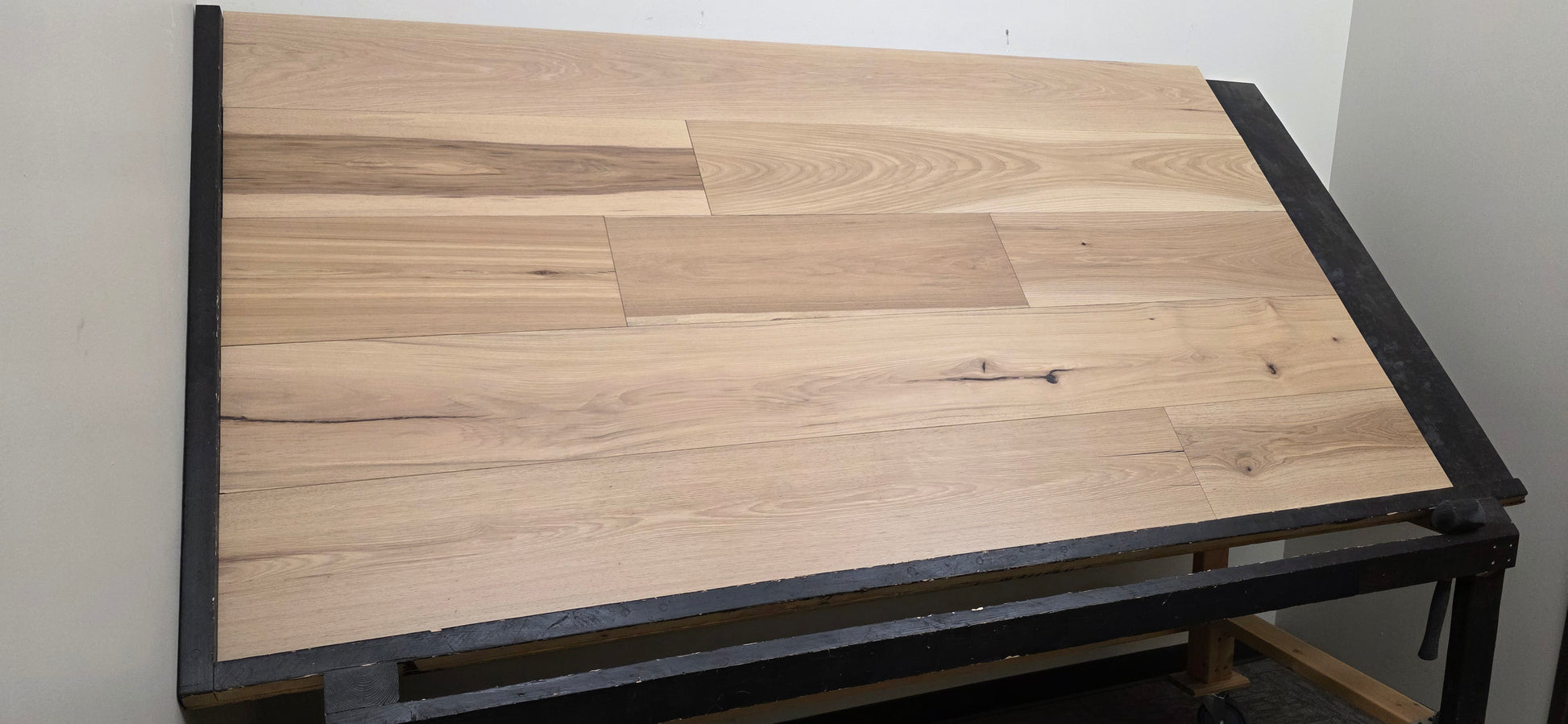 9 1/2" x 5/8" Engineered Hickory Chapman Hardwood Flooring on a black table left angle shot