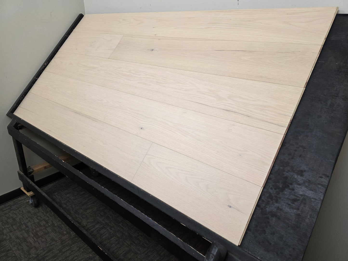 9 1/2" x 5/8" Engineered Red Oak Initium Hardwood Flooring on a black shooting table. wide angle right side shot