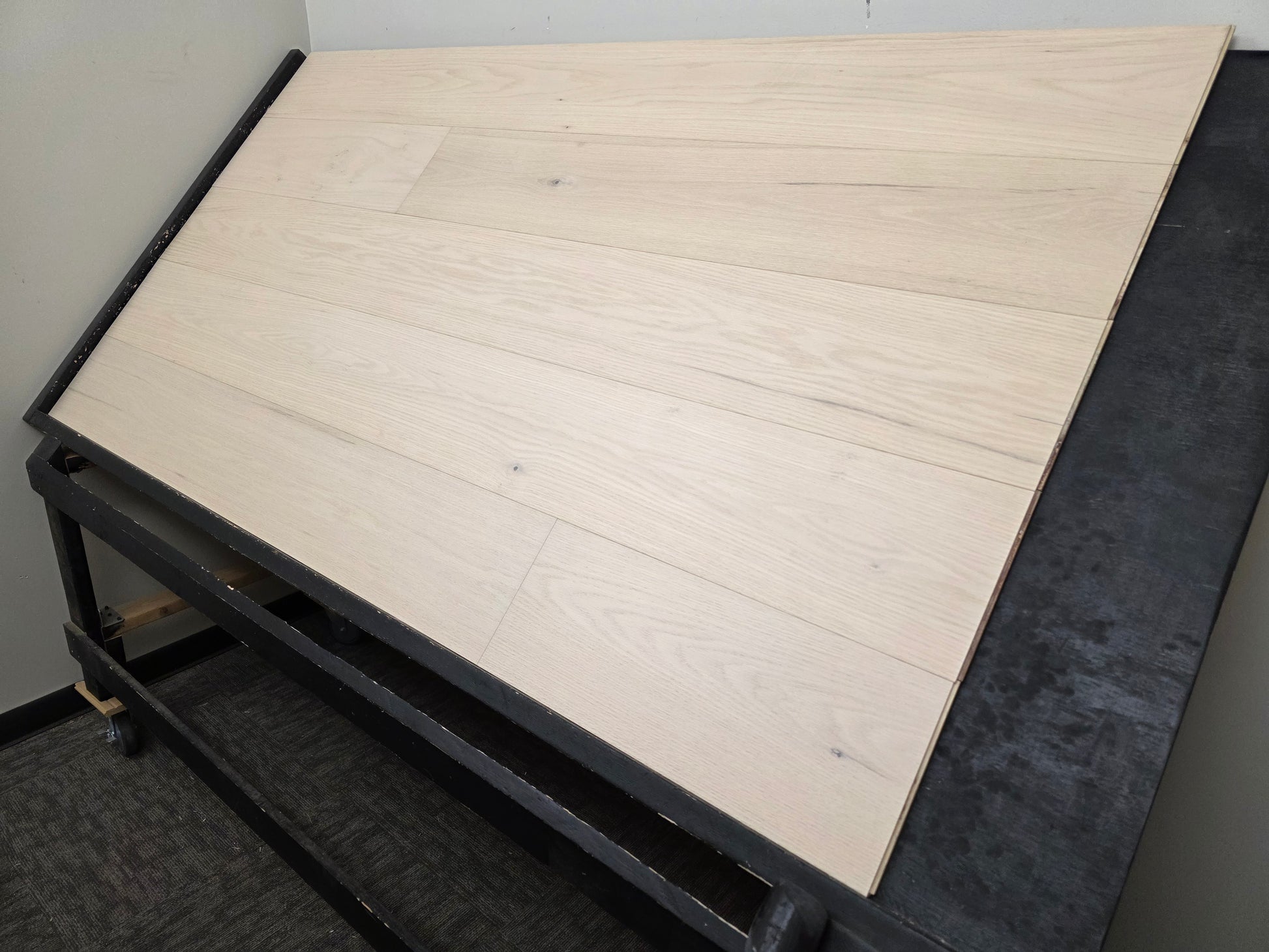 9 1/2" x 5/8" Engineered Red Oak Initium Hardwood Flooring on a black shooting table. wide angle right side shot