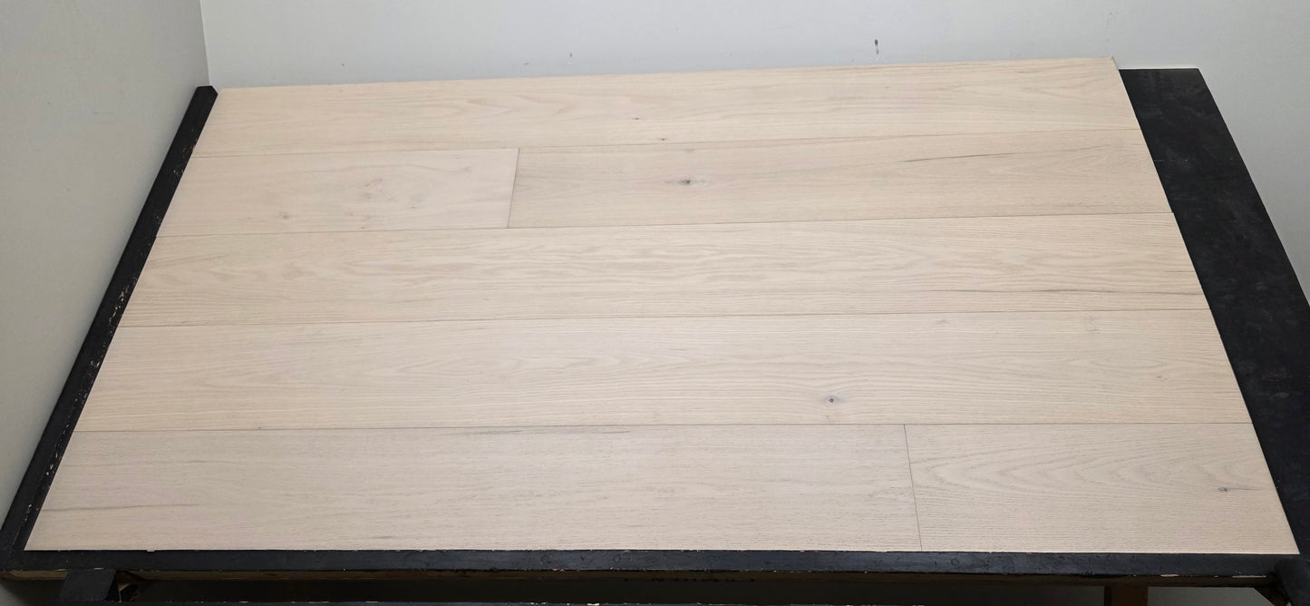 9 1/2" x 5/8" Engineered Red Oak Initium Hardwood Flooring on a black shooting table. Closeup shot 