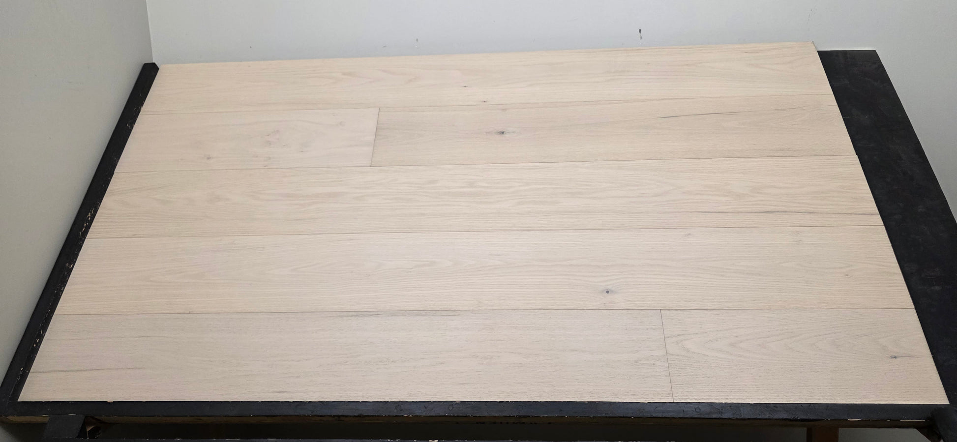 9 1/2" x 5/8" Engineered Red Oak Initium Hardwood Flooring on a black shooting table. Closeup shot 