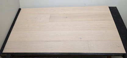 9 1/2" x 5/8" Engineered Red Oak Initium Hardwood Flooring on a black shooting table. Closeup shot 