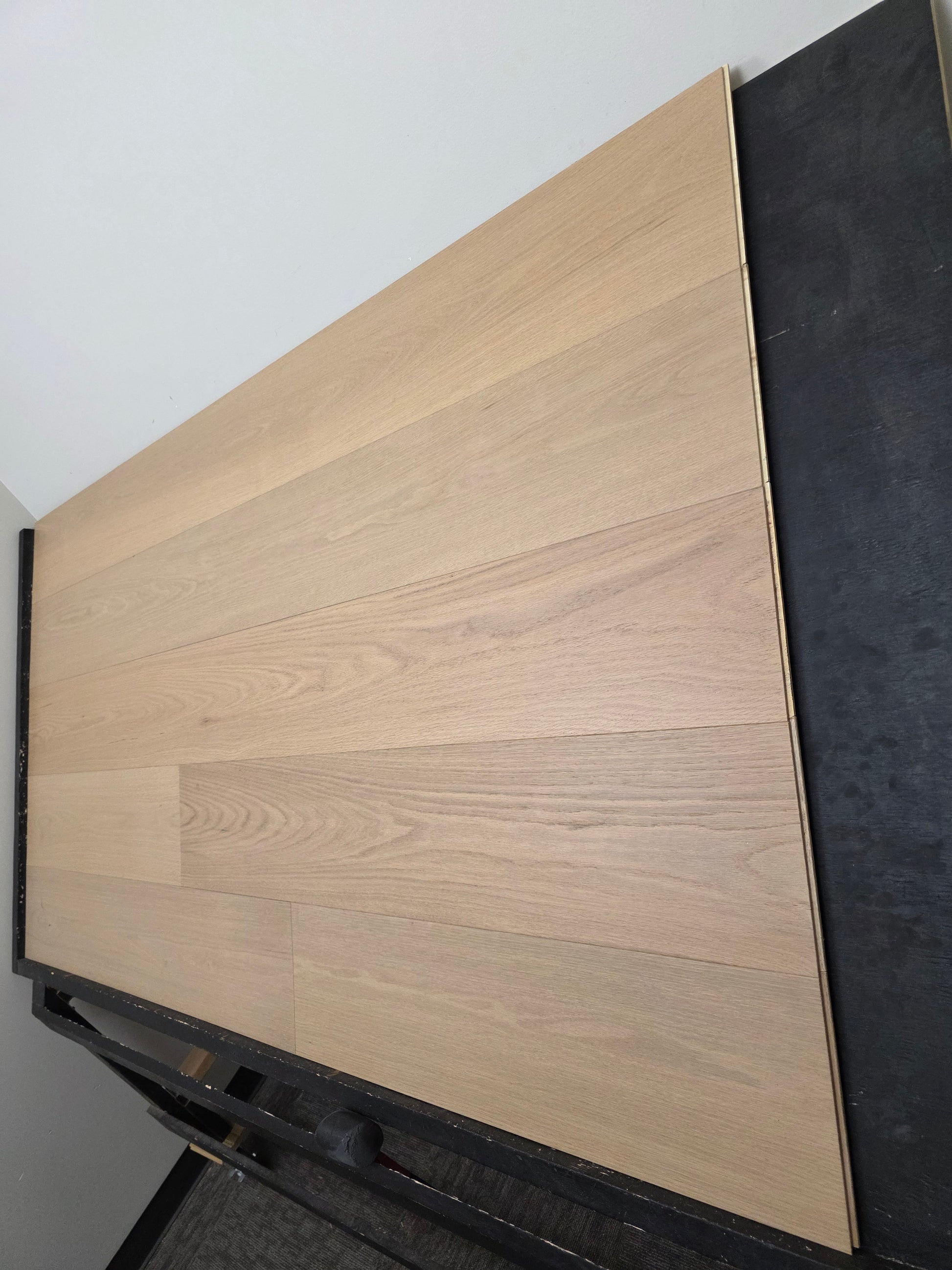 9 1/2" x 5/8" Engineered Red Oak Ophelia Hardwood Flooring on a black racking table. Wide shot right side
