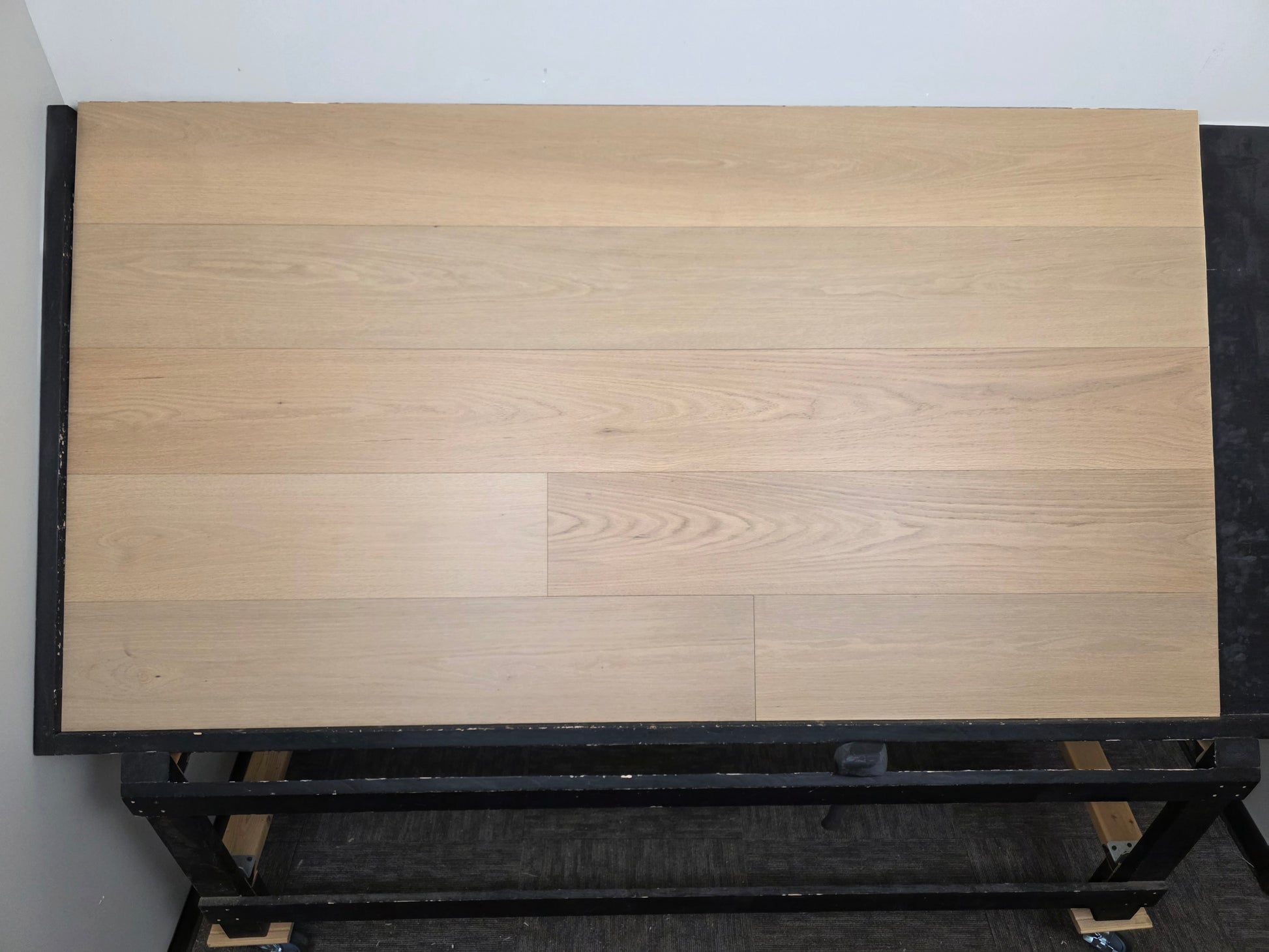 9 1/2" x 5/8" Engineered Red Oak Ophelia Hardwood Flooring on a black racking table.  Far back head on shot.