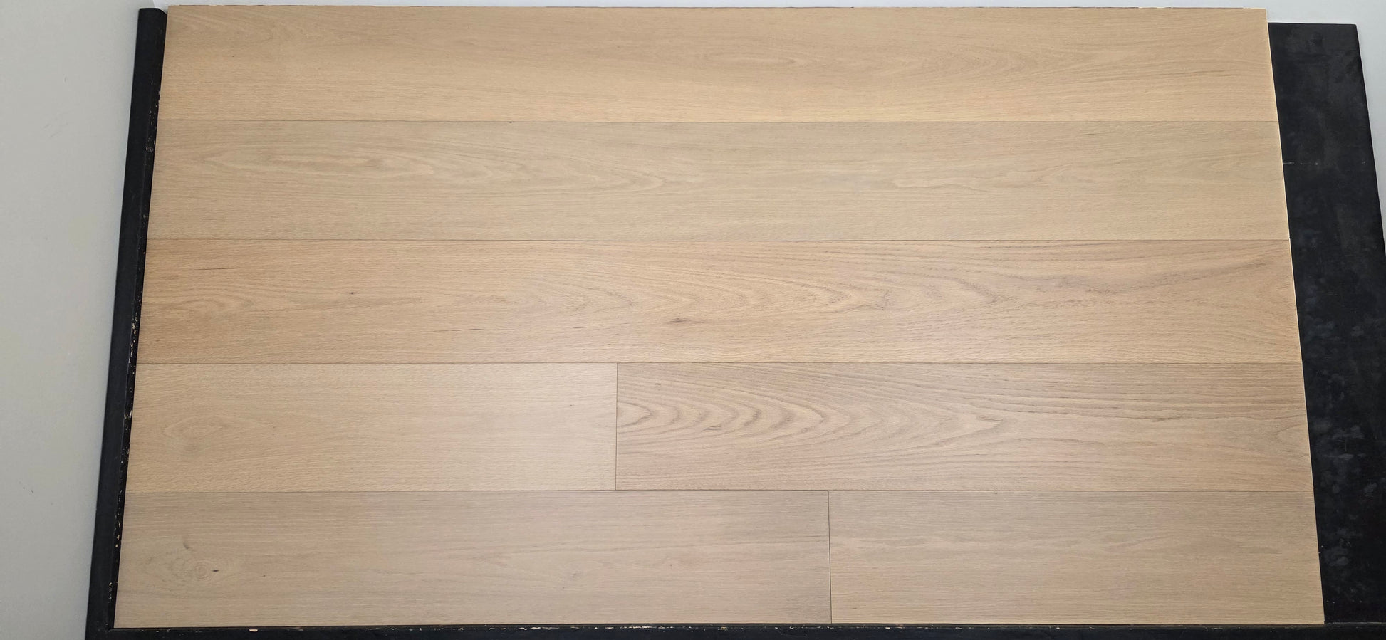 9 1/2" x 5/8" Engineered Red Oak Ophelia Hardwood Flooring on a black racking table. head on shot