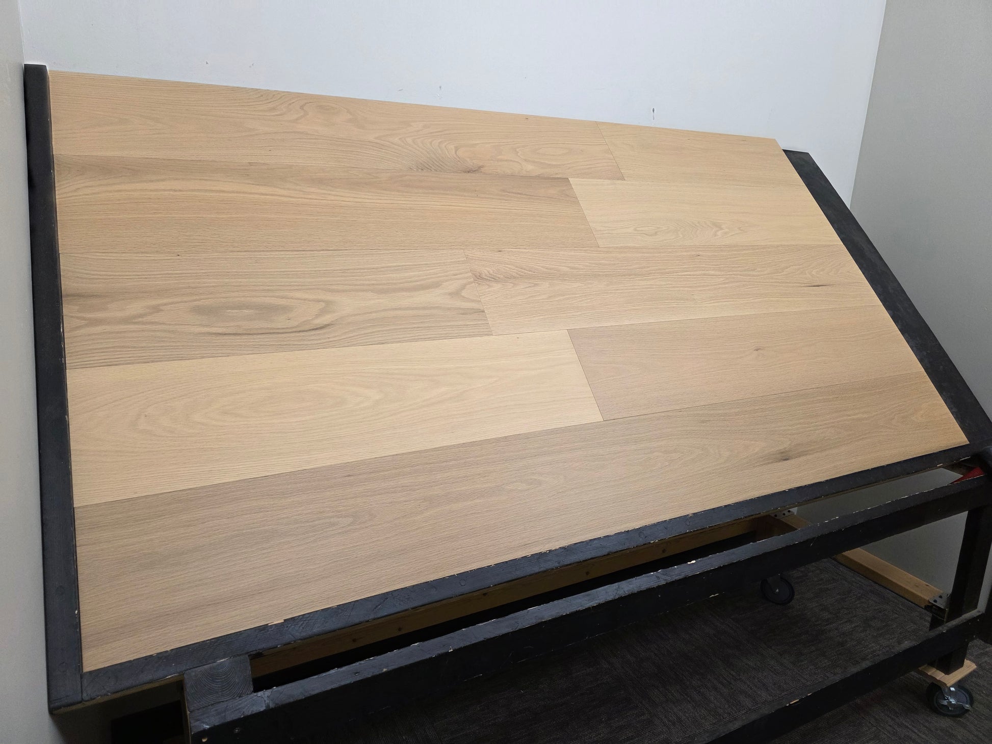 9 1/2" x 5/8" Engineered White Oak Sparrow Hardwood Flooring. Shown on a black shooting rack left hand side.