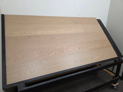 9 1/2" x 5/8" Engineered White Oak Swan Hardwood Flooring. Shown on a black shooting rack. left side shot.