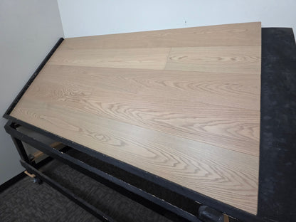 9 1/2" x 5/8" Engineered White Oak Swan Hardwood Flooring. Shown on a black shooting rack. Shown from the right side. 