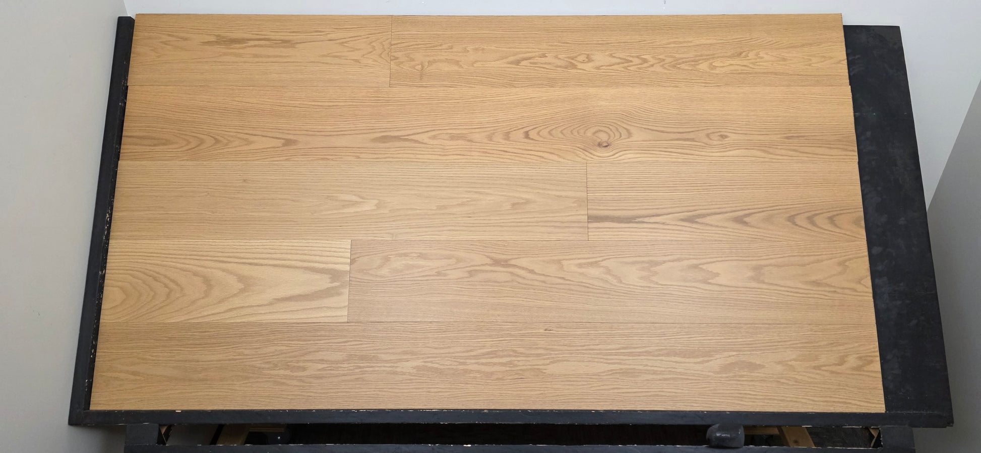 9 1/2" x 5/8" Engineered White Oak Wren Hardwood Flooring shown on a black shooting table. Head on shot. 