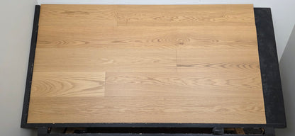9 1/2" x 5/8" Engineered White Oak Wren Hardwood Flooring shown on a black shooting table. Head on shot. 