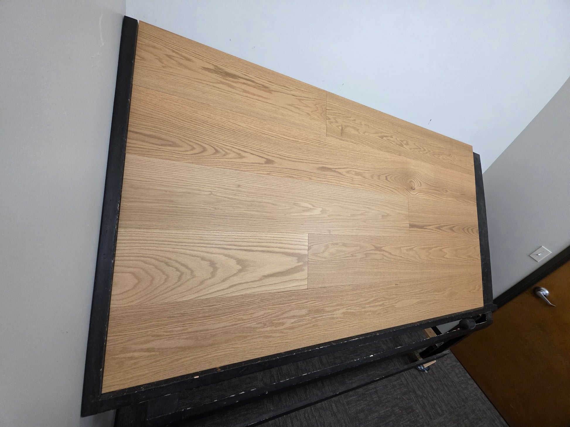 9 1/2" x 5/8" Engineered White Oak Wren Hardwood Flooring shown on a black shooting table. left hand shot.