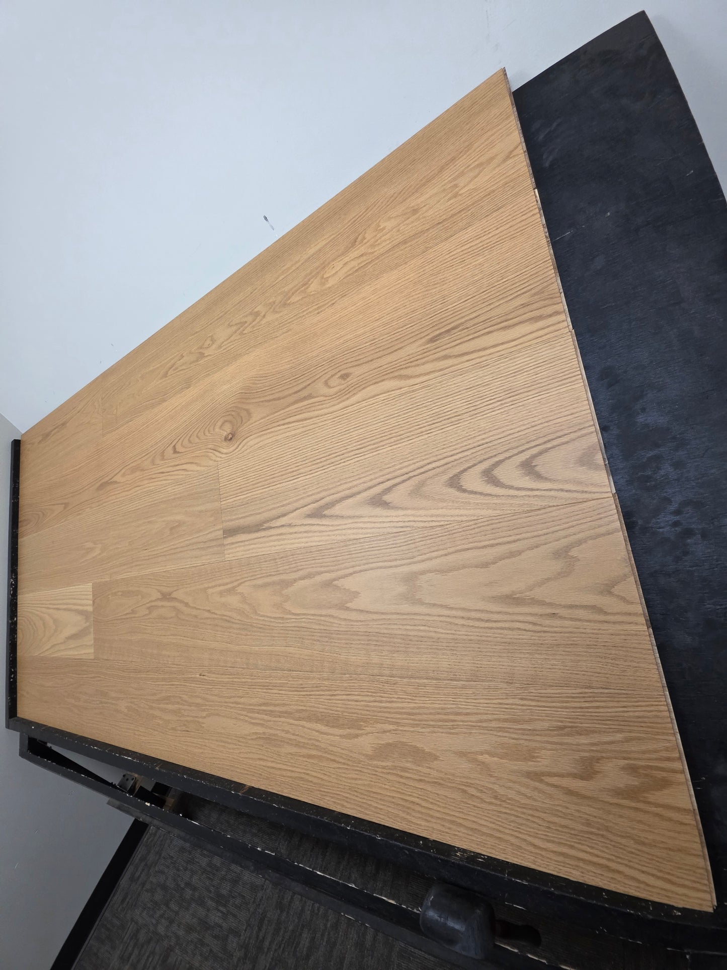 9 1/2" x 5/8" Engineered White Oak Wren Hardwood Flooring shown on a black shooting table. Shot from the right hand side. 