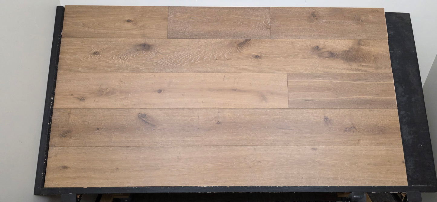 9 1/2" x 9/16" Engineered White Oak Atlas Hardwood Flooring shown on a black shooting table. Center shot.