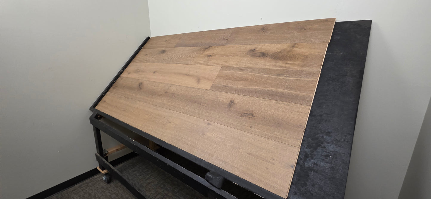 9 1/2" x 9/16" Engineered White Oak Atlas Hardwood Flooring shown on a black shooting table. Shot from a steep right angle. 