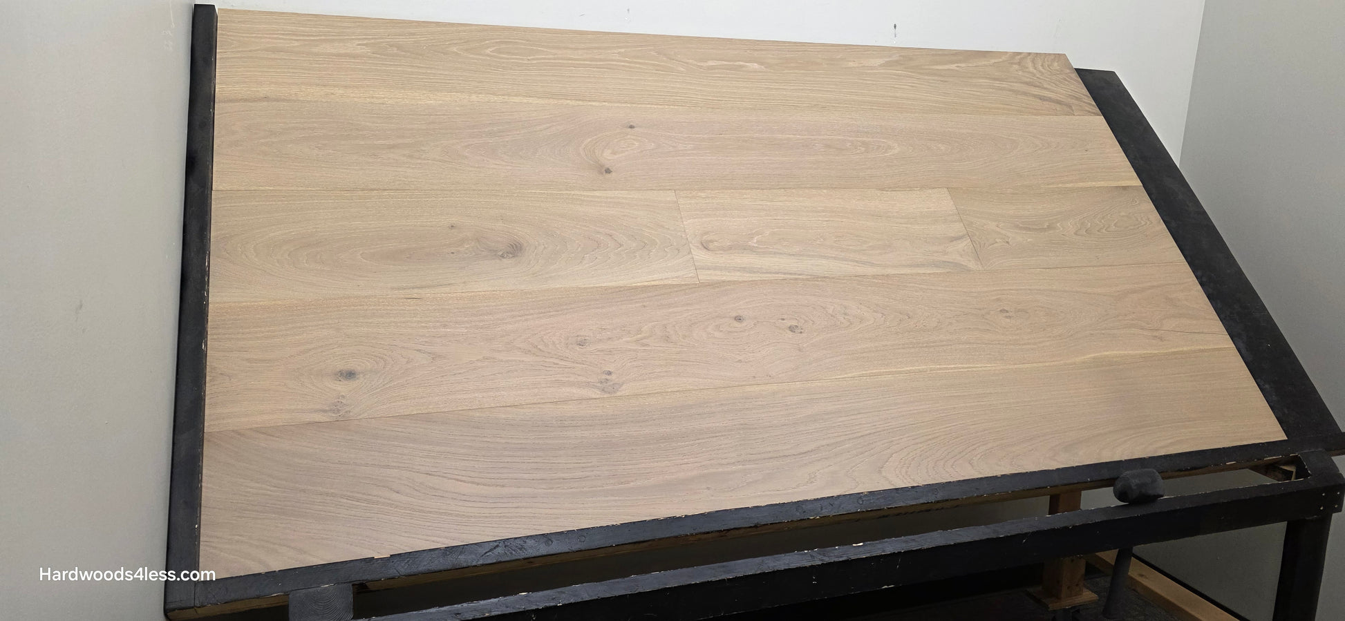 9 1/2" x 9/16" Engineered White Oak Daphne Hardwood Flooring shown on a black shooting table on wide left angle shot.