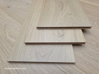 9 1/2" x 9/16" Engineered White Oak Daphne Hardwood Flooring shown as three pieces stacks atop eachother.